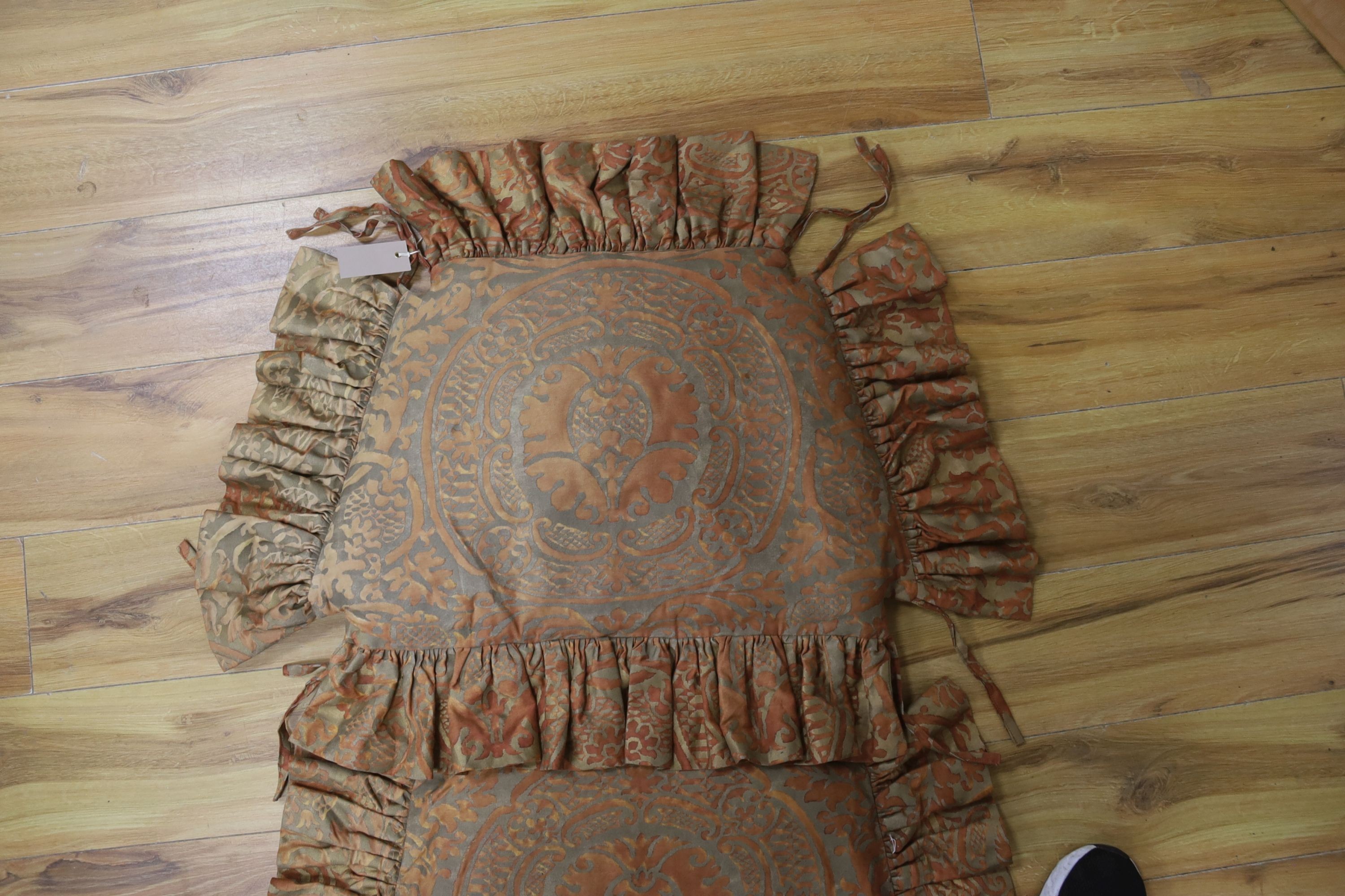 A pair of Fortuni 'Orsini pattern' seat cushions in rust and gold colourway